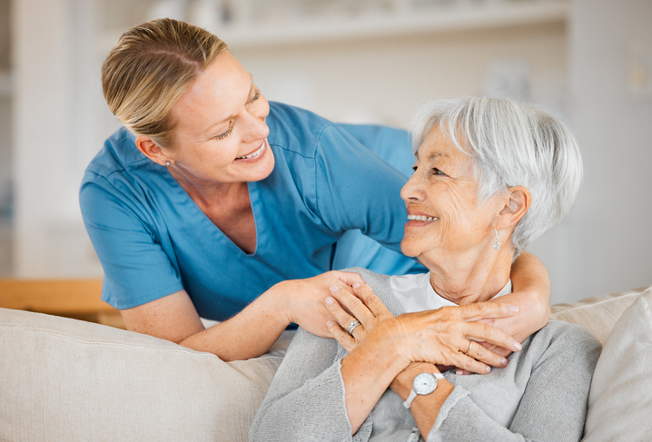 Shot of a nurse caring for a senior woman at home